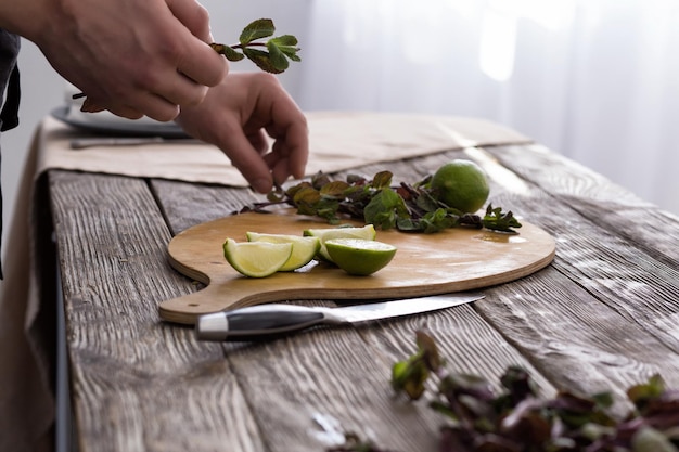 Chef arranging herbs on cutting board